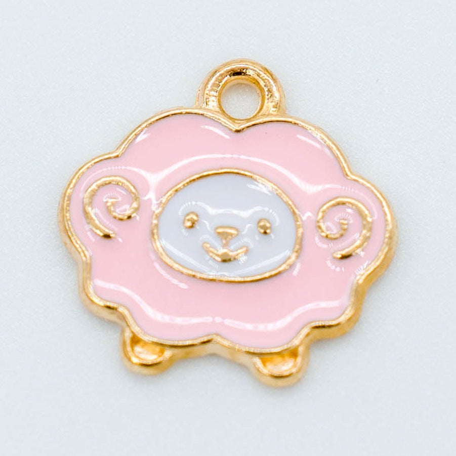 Pink metal sheep charm with gold-toned backing