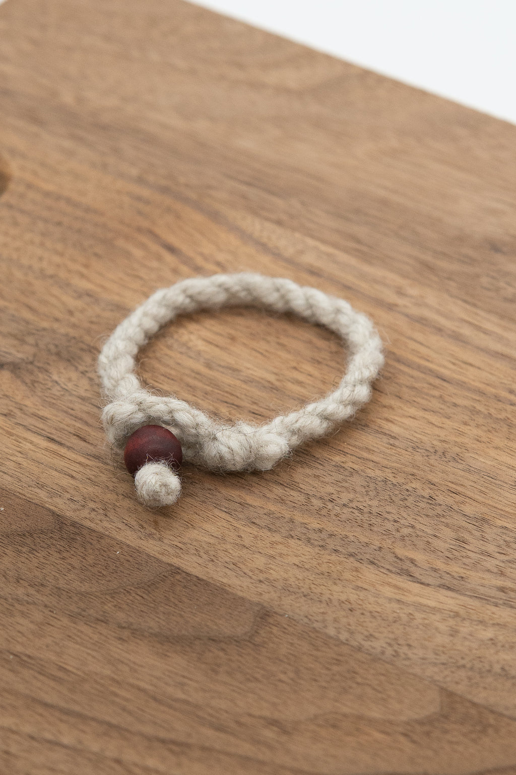 Apricot's wool bracelet on a wooden background