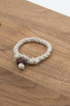 Apricot's wool bracelet on a wooden background