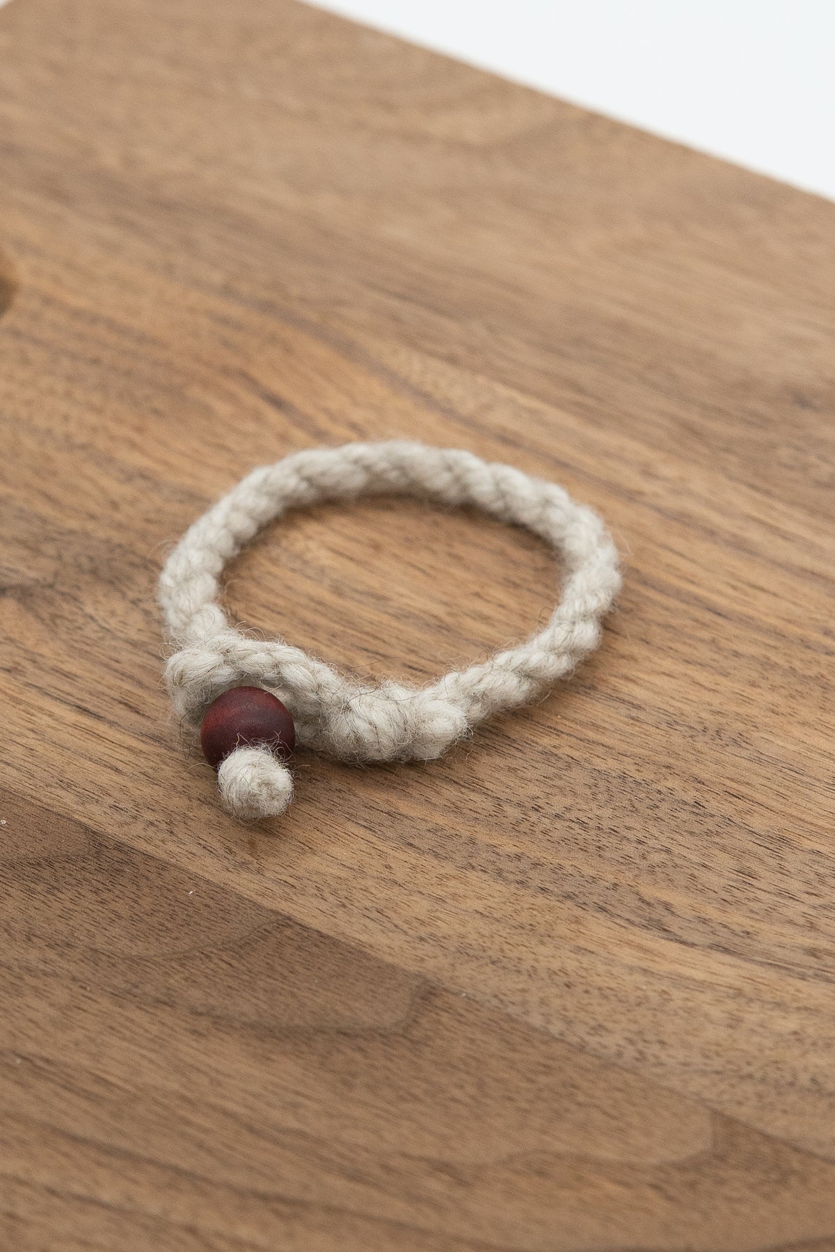 Apricot's wool bracelet on a wooden background