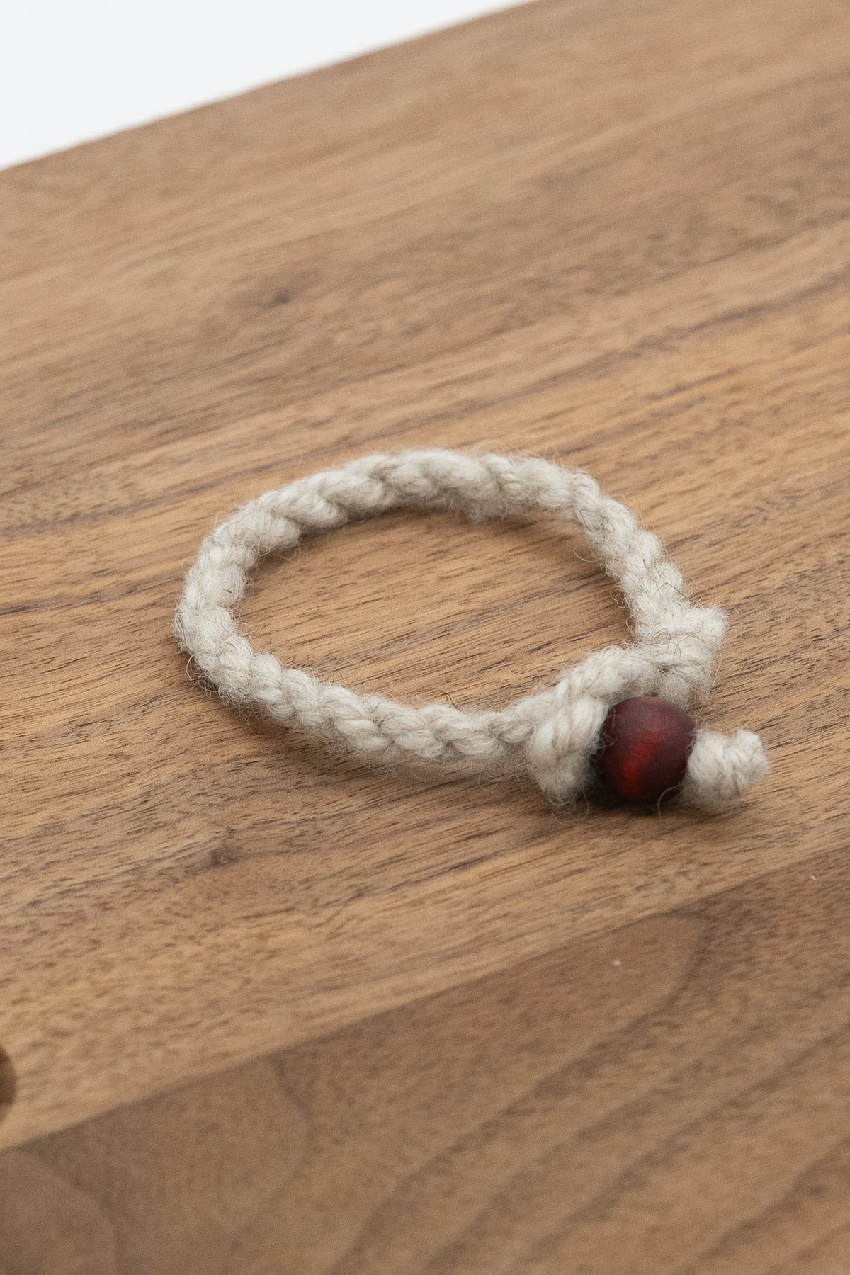 handmade wool bracelet from Apricot the Shetland sheep on a wooden background