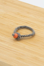 natural light gray wool bracelet made from Eddie the Shetland sheep on a wooden background
