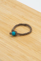Brown wool bracelet handmade from Paula the Shetland sheep on a wooden background