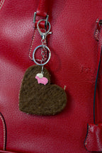 Brown felted bag charm made from Chops the Shetland ram with a pink sheep charm and red purse