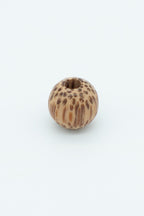 Variegated brown natural wooden bead solo image for a wool bracelet