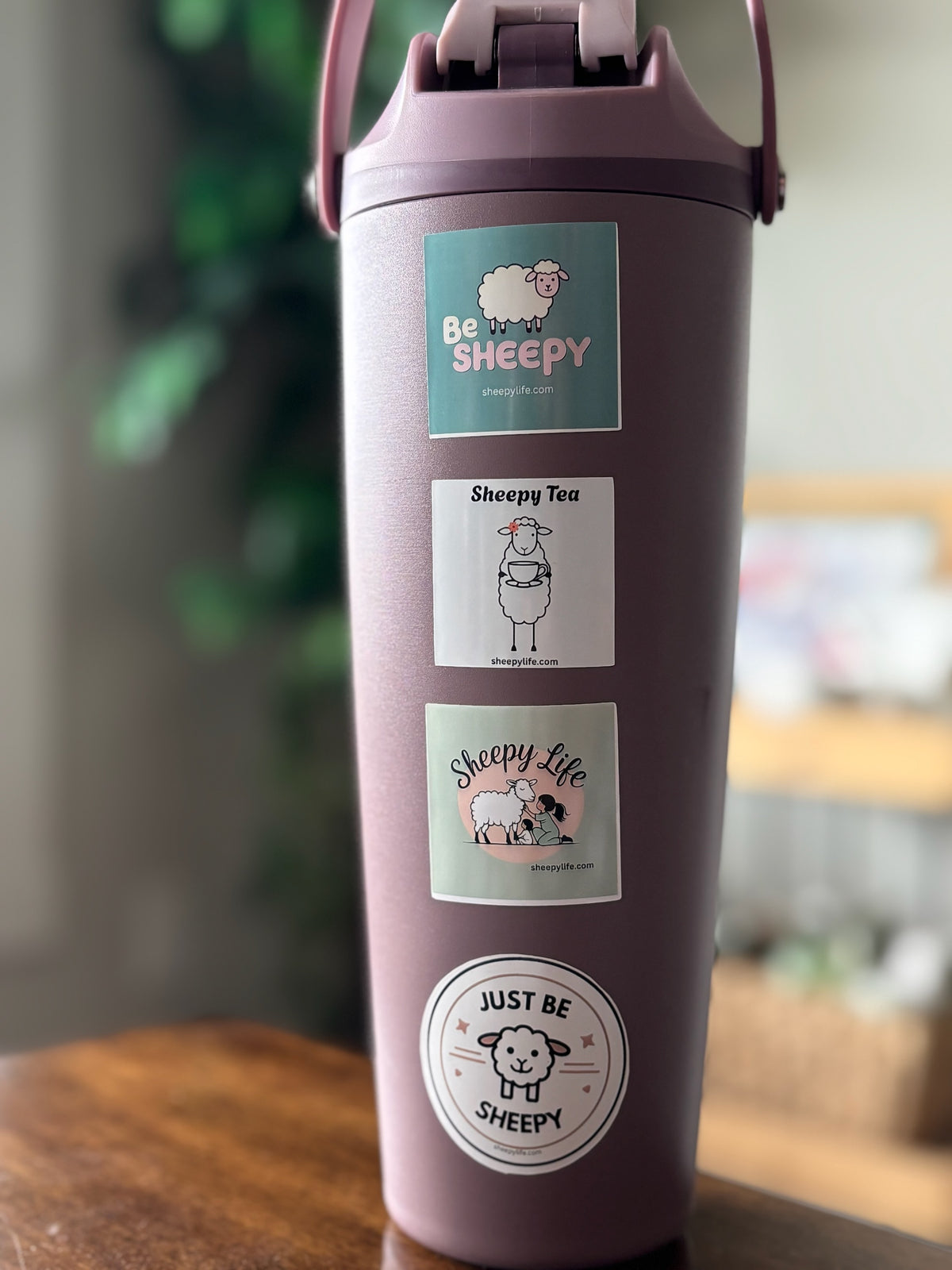 Mauve water bottle with sheep stickers on it from Sheepy Life